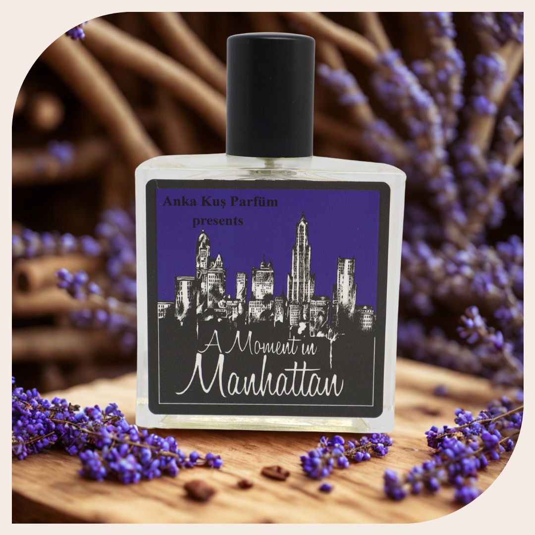 Flat lay of A Moment In Manhattan perfume with blueberries, croissant, and coffee – gourmand and cozy scent aesthetic