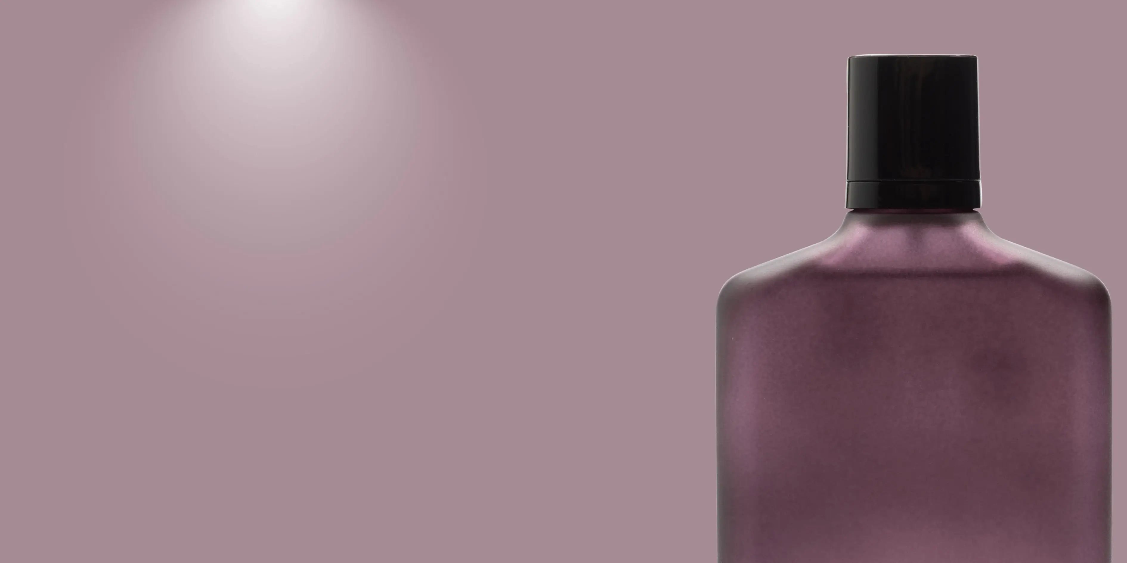 Purple bottle with black cap on a pinkish-purple background