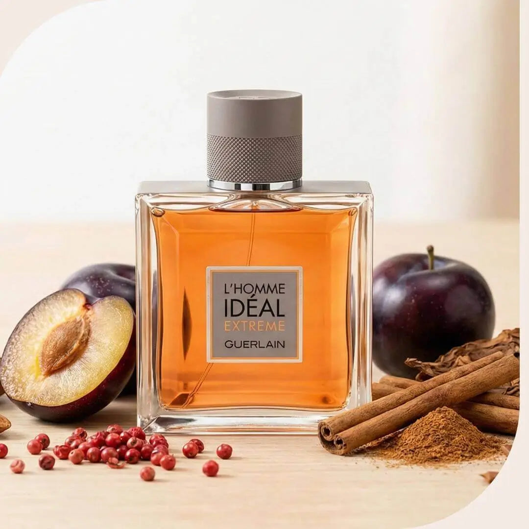 Guerlain L'Homme Idéal Extrême Eau de Parfum 100ml Tester bottle displayed with its key ingredients: sliced plums, cinnamon sticks, and dried tobacco leaves.